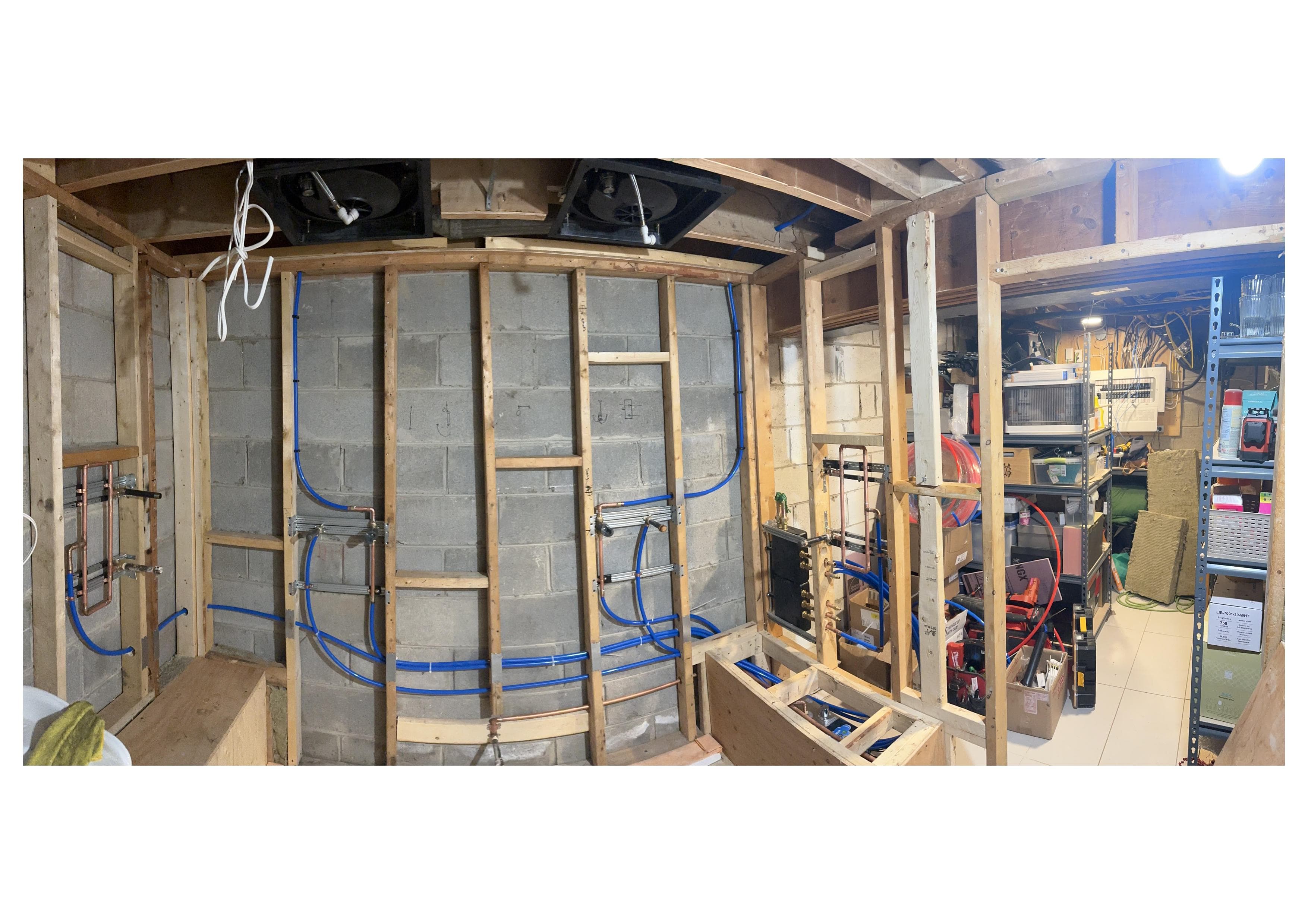 Basement utility room plumbing rough-in with organized pipe runs